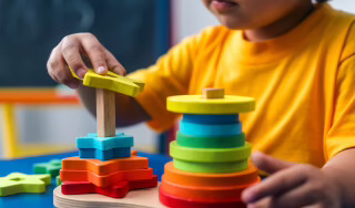 Child playing with toy in nursery