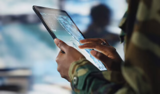 Man using Tablet device for defence purposes